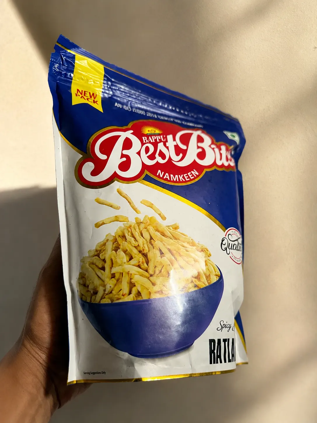 Holding a Ratlami Sev pack in the sun